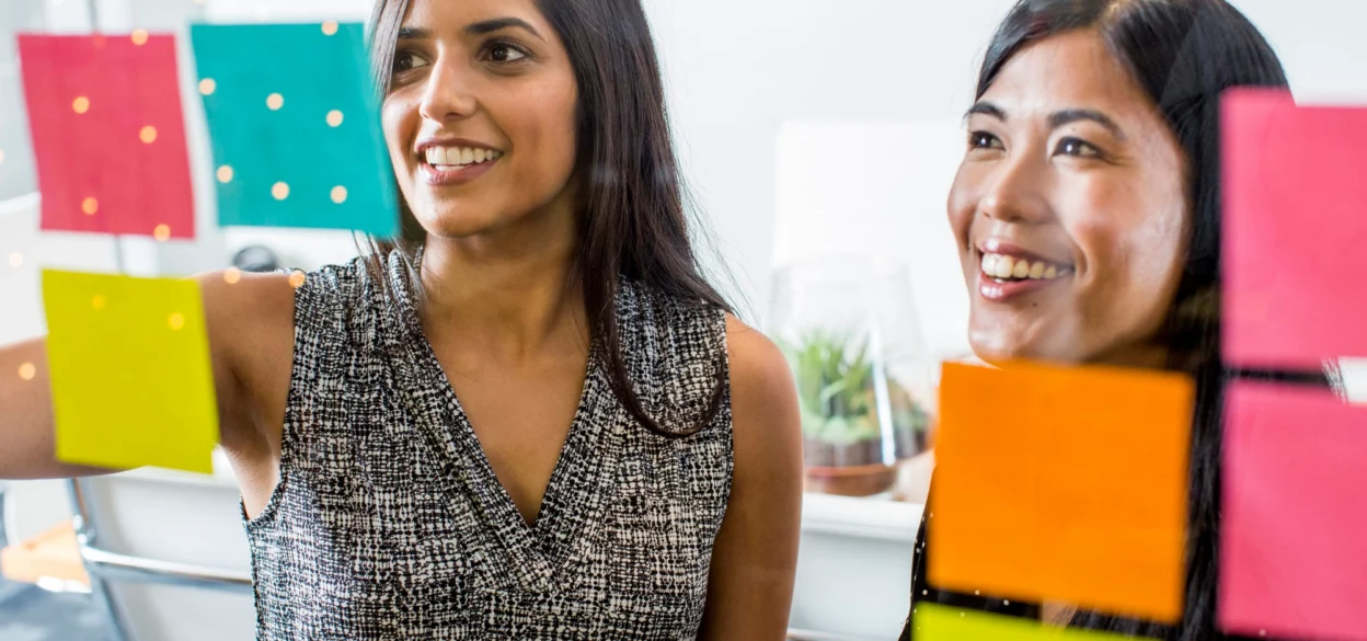 Two people looking at post-its
