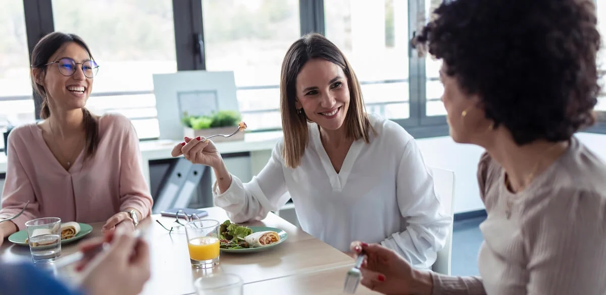 Colleagues eating and talking