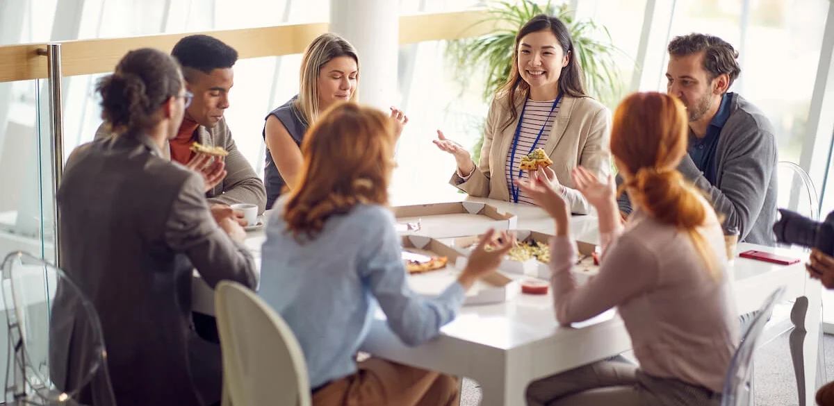 group of colleagues eating at a white table