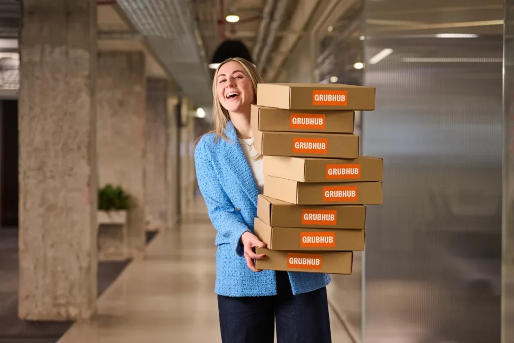 Person walking carrying Grubhub meals